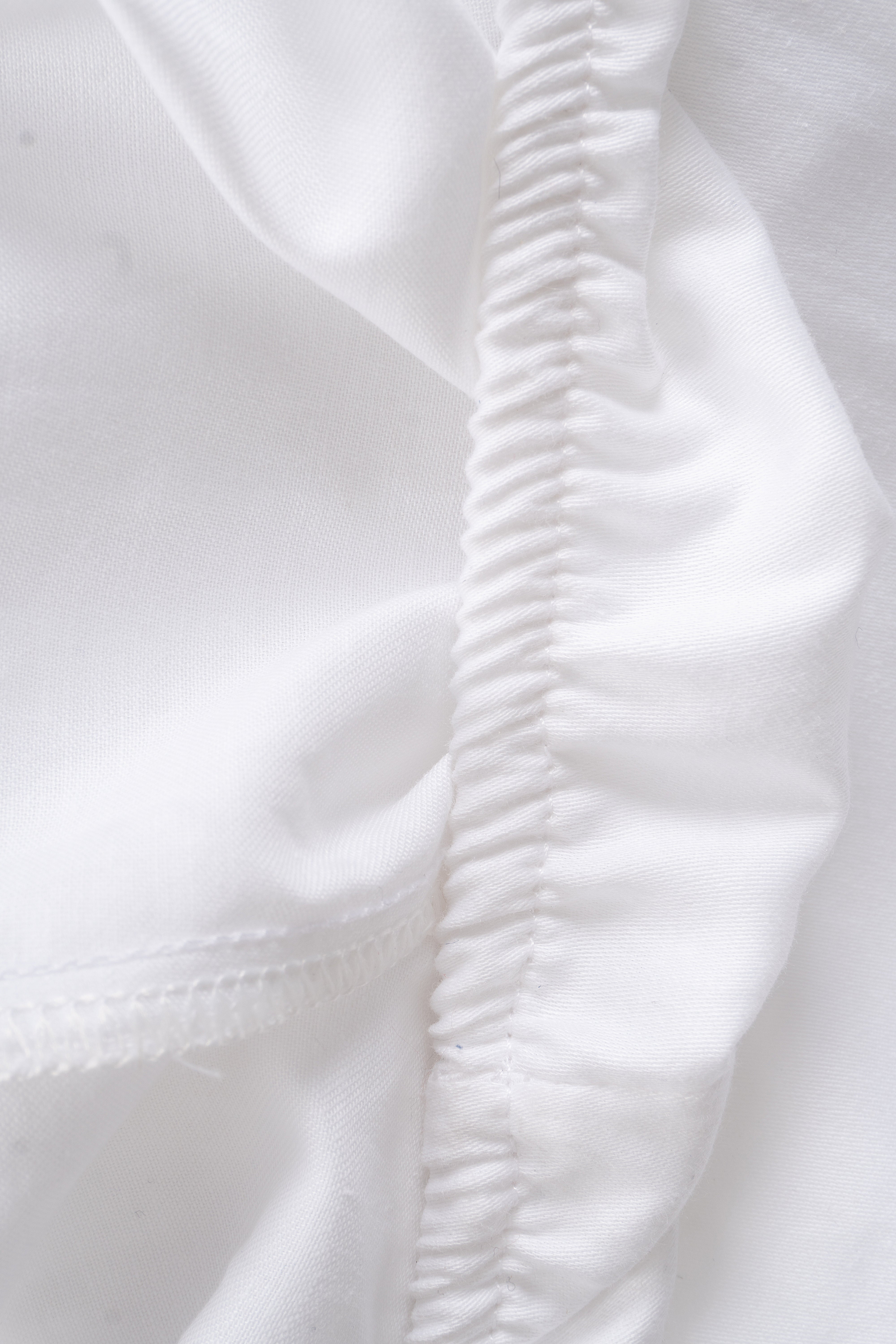 Luxurious Mediterrane Adjustable Sheet in soft, neutral tones, crafted from a premium 250-thread-count cotton-polyester blend for ultimate comfort.