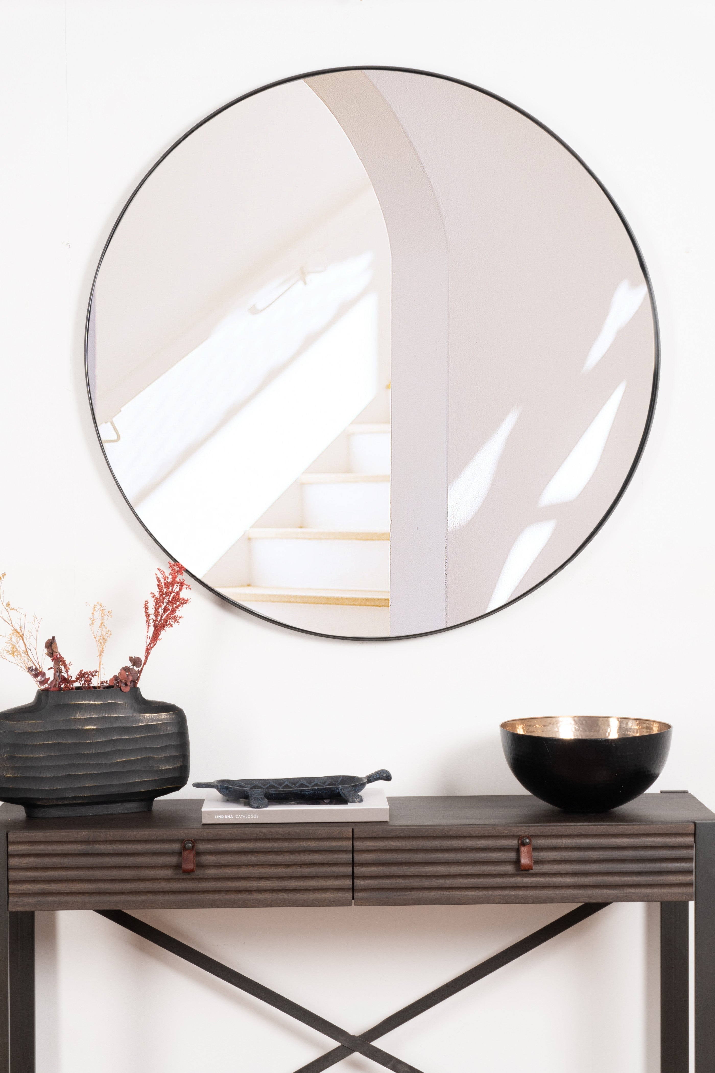 Elegant round Rotterdam mirror with a sleek steel frame, adding modern sophistication and brightness to any room.