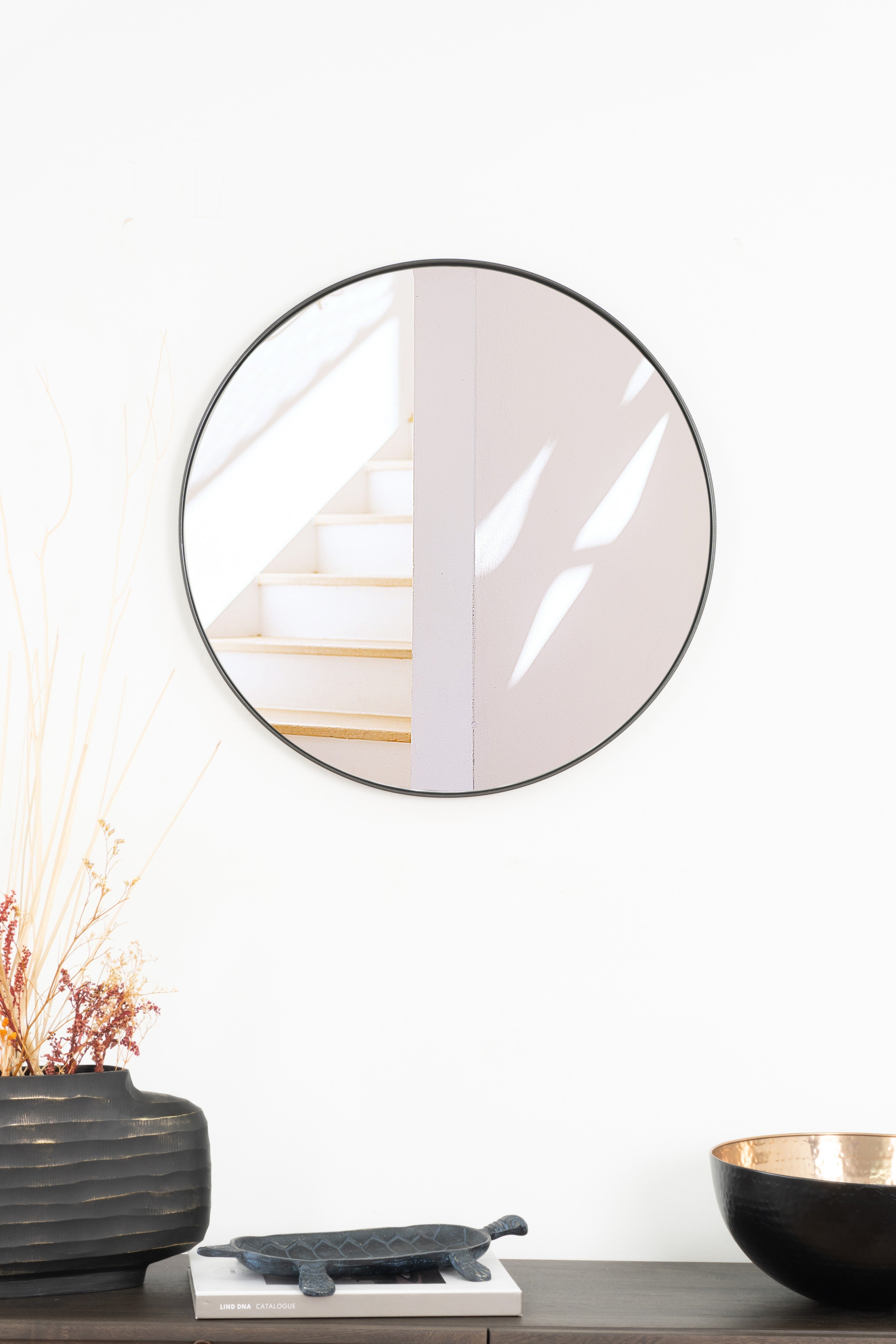Elegant round Rotterdam mirror with a sleek steel frame, adding modern style and brightness to any room.