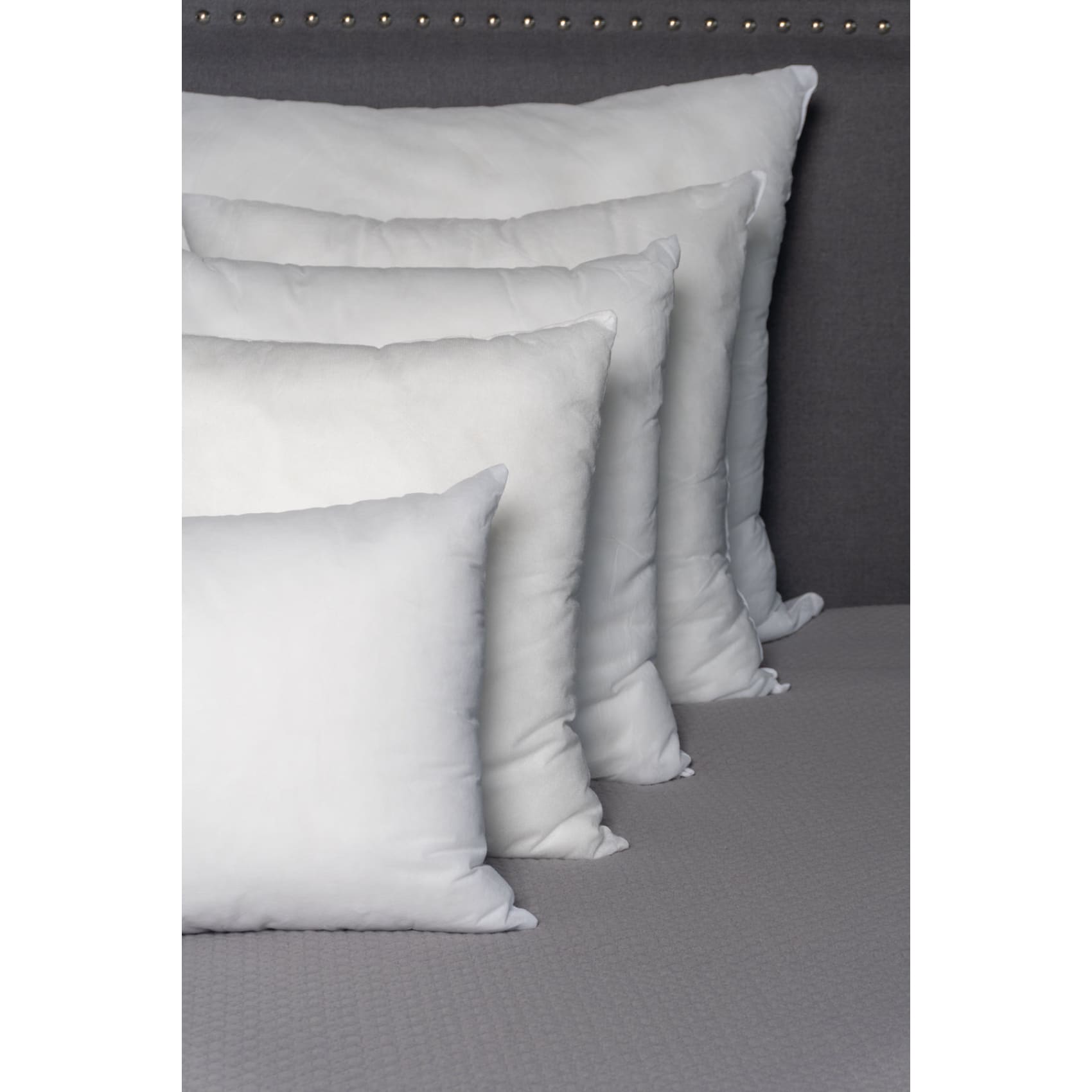 Soft and fluffy Ecoplumas cushion fillings in various sizes, perfect for adding cozy volume to your bed or sofa.