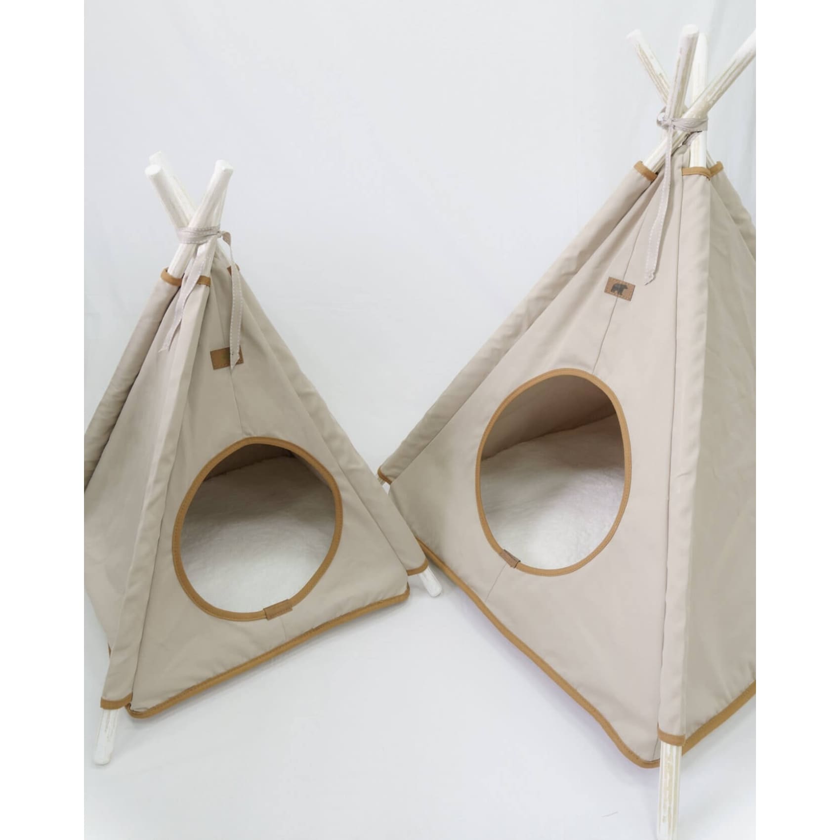 Cozy beige Teepe Pets Bongo tent for pets, crafted from durable canvas with wooden supports and a soft, removable mat.